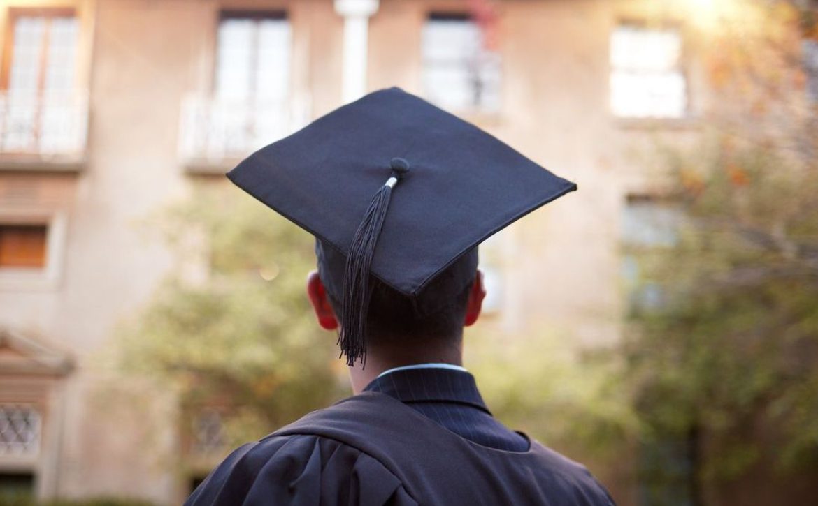 Thinking graduate, man or vision on university campus, college event or school graduation ceremony and future goals. Graduation cap, robe or student with education, learning or employment opportunity