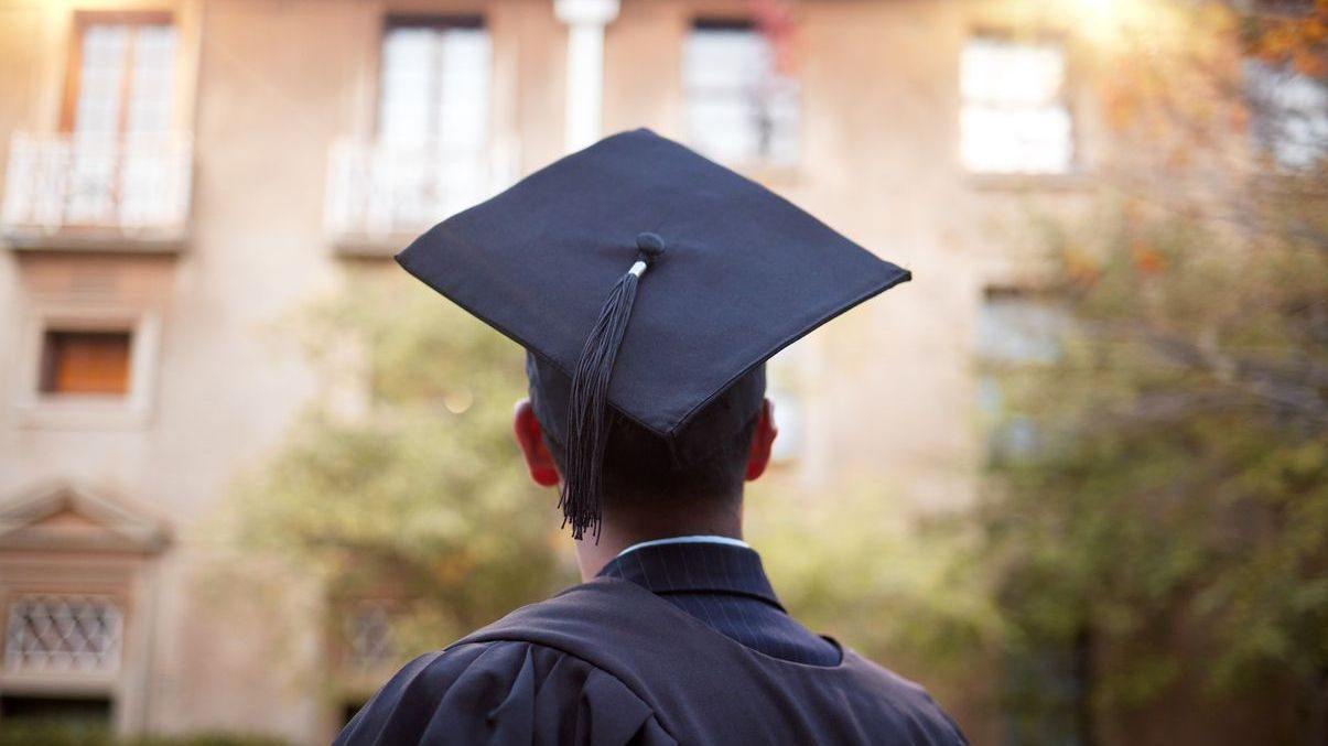 Thinking graduate, man or vision on university campus, college event or school graduation ceremony and future goals. Graduation cap, robe or student with education, learning or employment opportunity