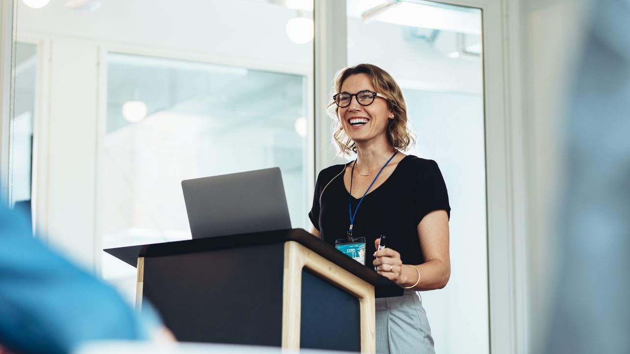 Female business professional addressing a seminar