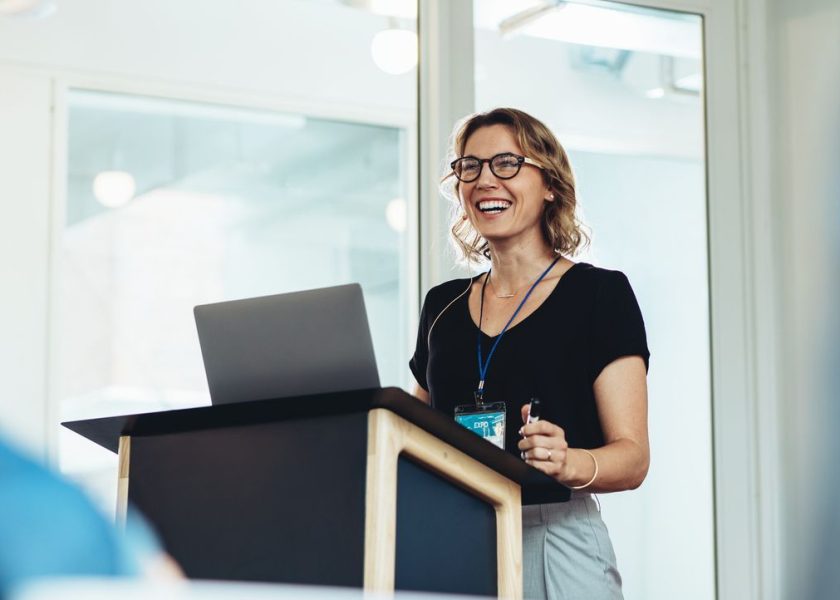 Female business professional addressing a seminar