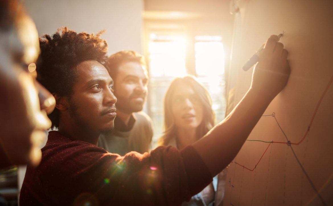 Group of business people analyzing a graph in the office.