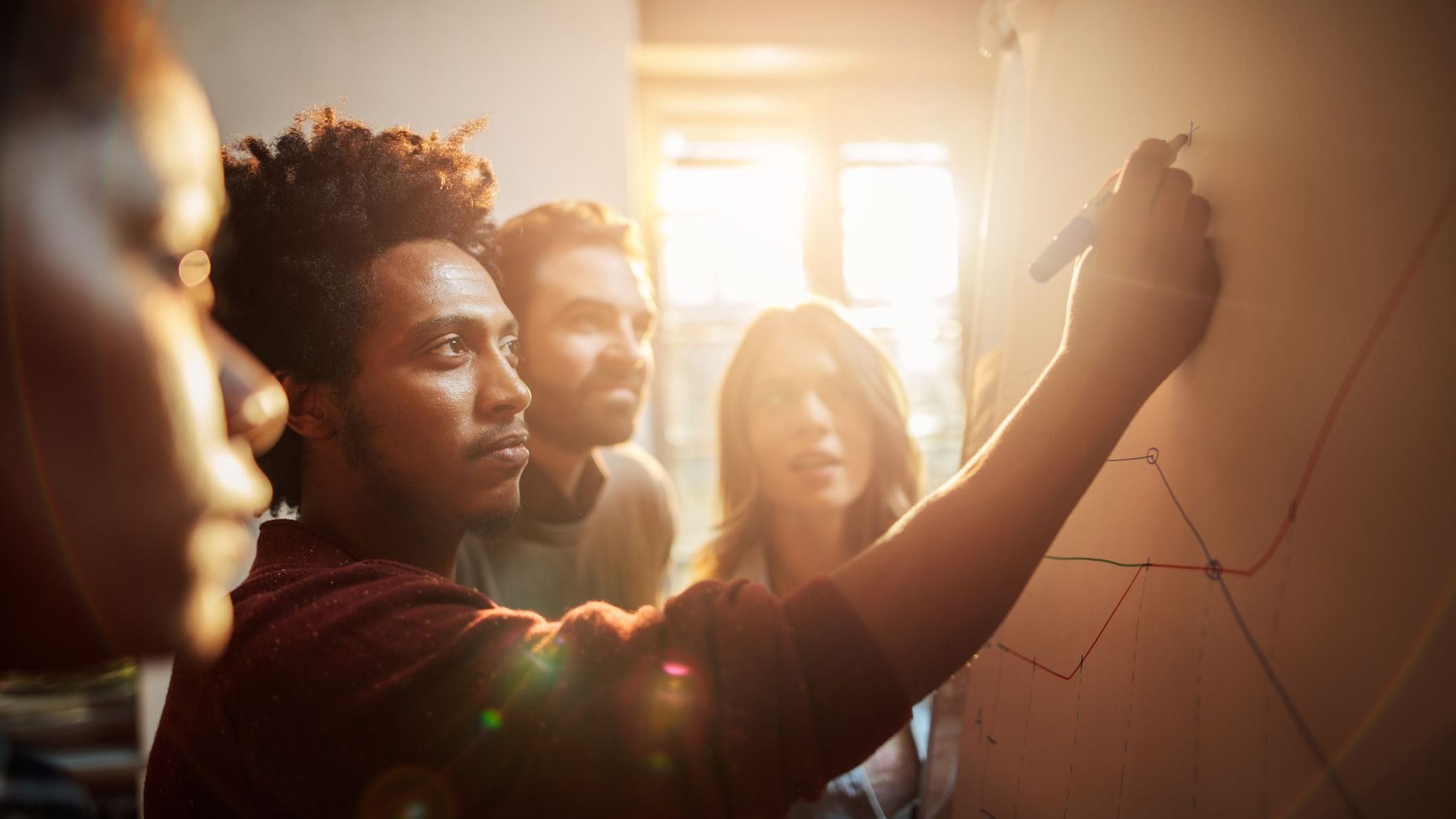 Group of business people analyzing a graph in the office.