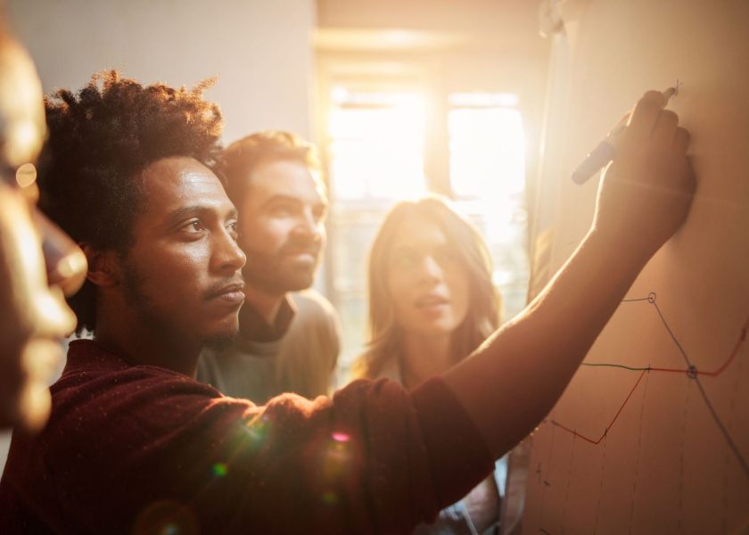 Group of business people analyzing a graph in the office.