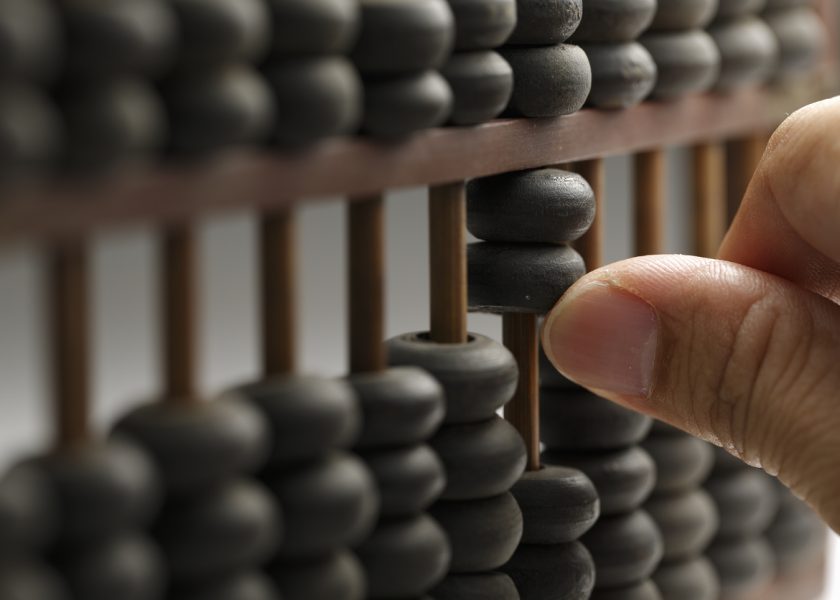 Man hands are operating abacus